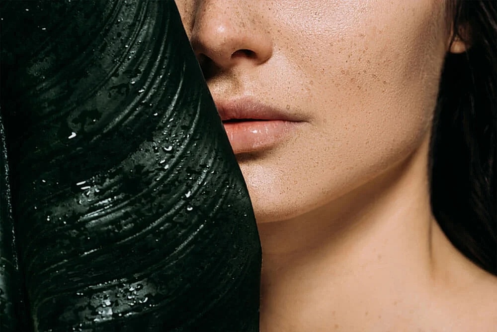 Close-up of a woman's face and hand.