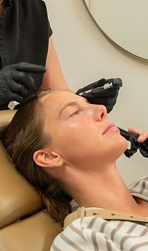 Woman receiving a beauty treatment in a clinic.