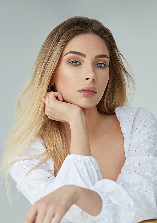 Portrait of a woman with long blonde hair.