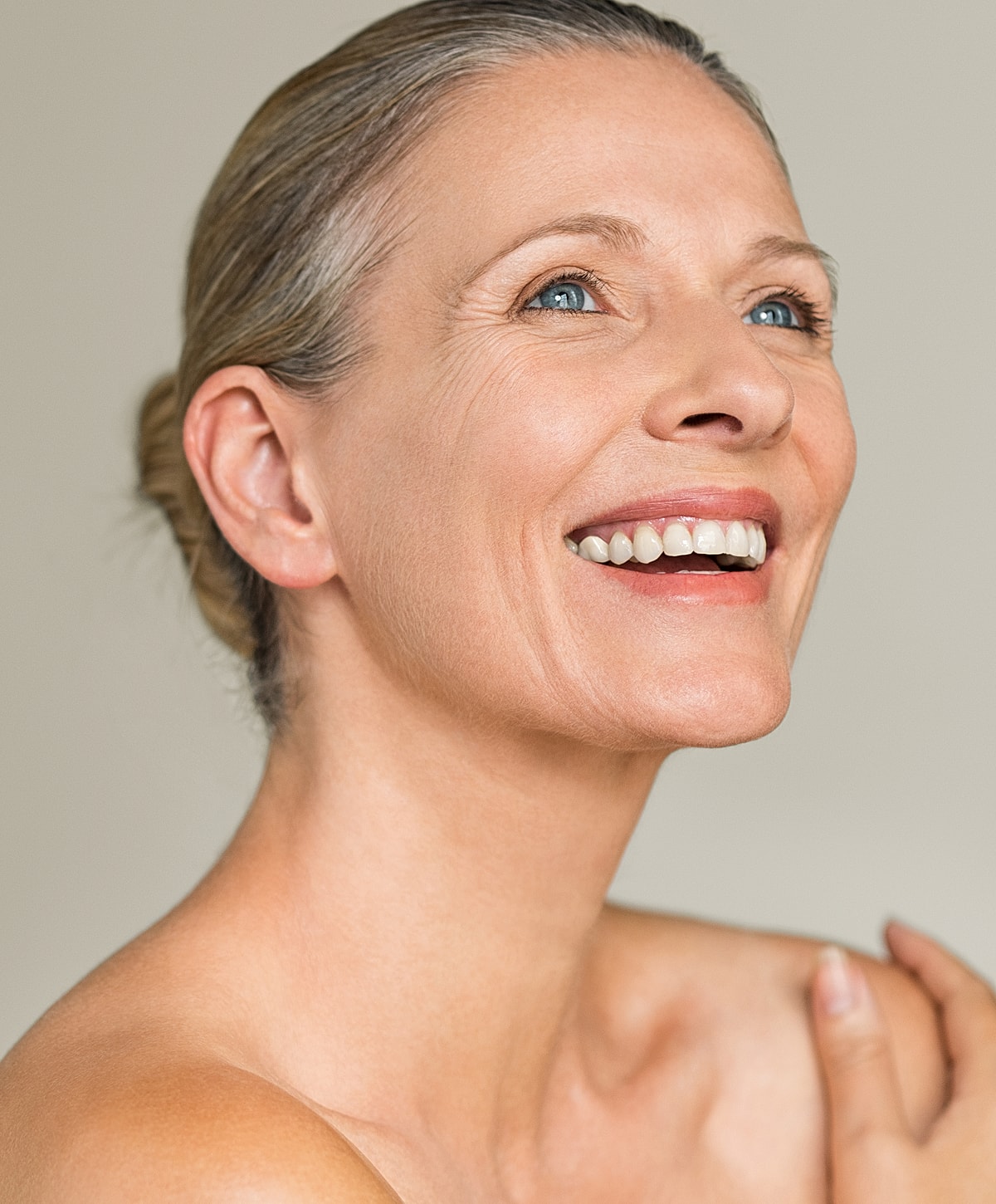 Smiling woman with light skin and blue eyes.