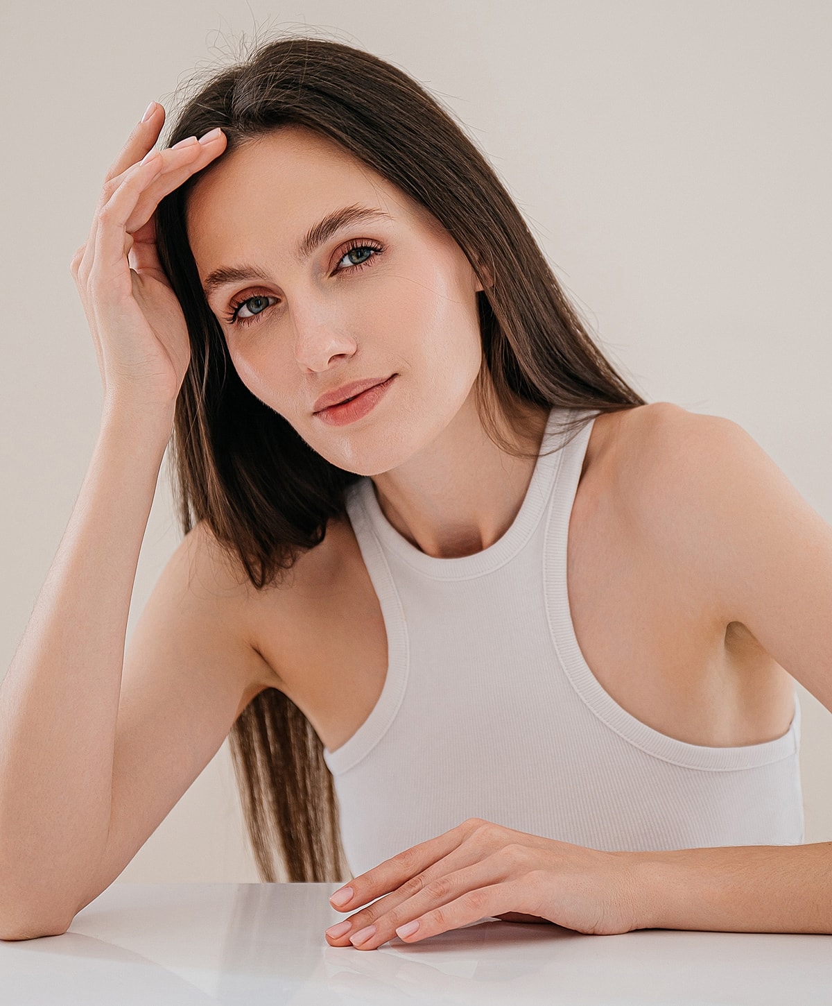 Woman with long hair resting her hand.