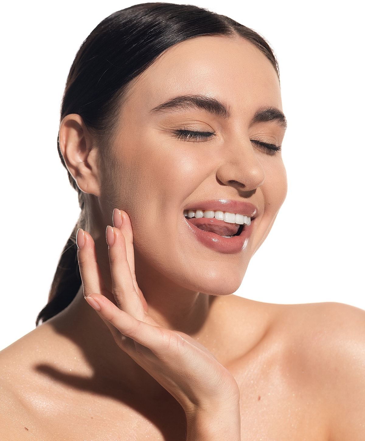 Smiling woman with flawless skin and posed hand.