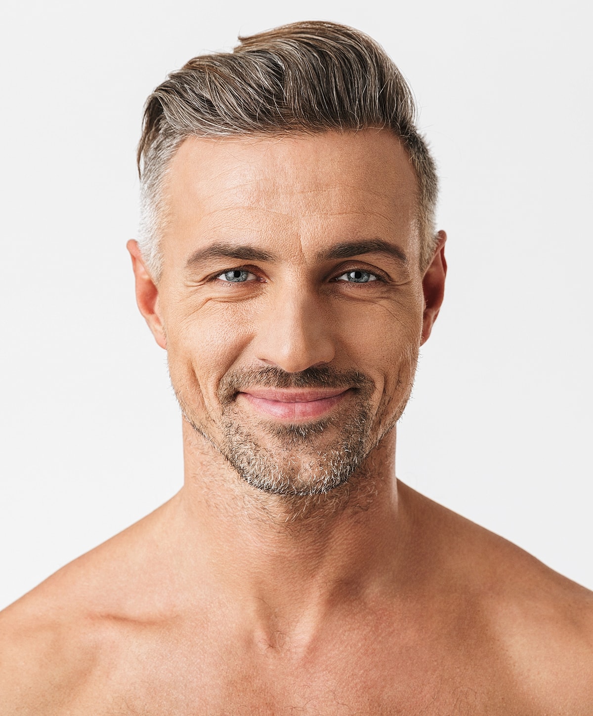 Smiling man with stylish hair and beard.