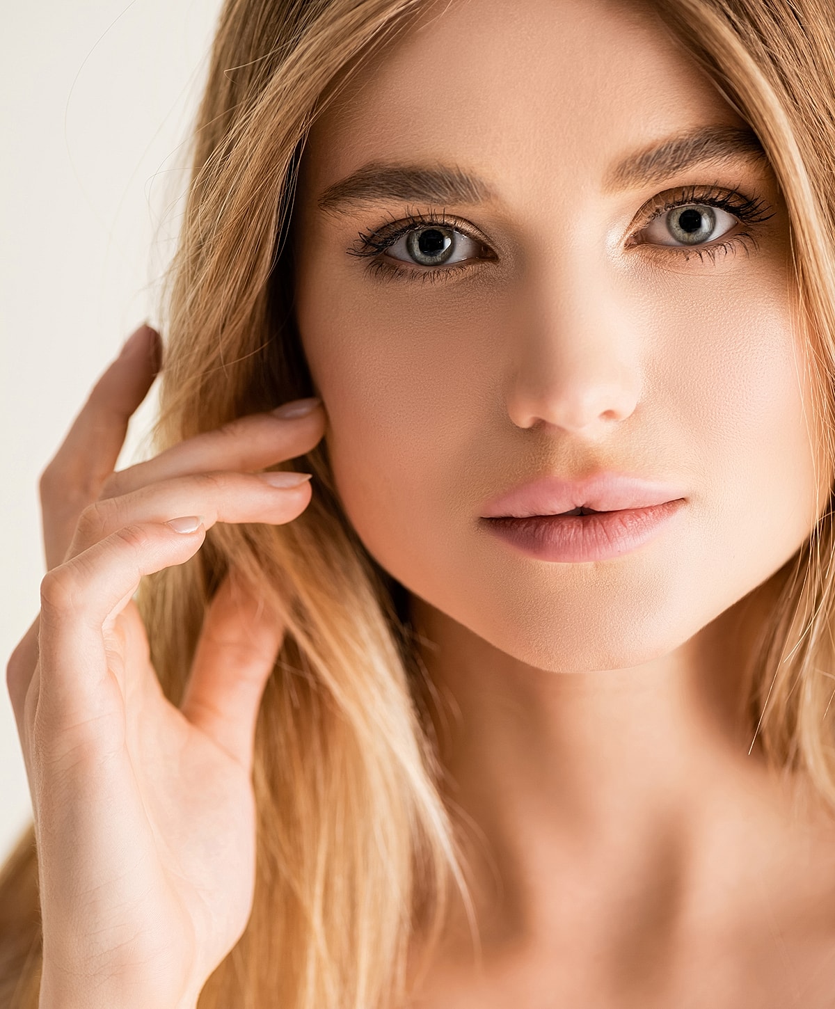 Close-up of a woman's face with soft expression.