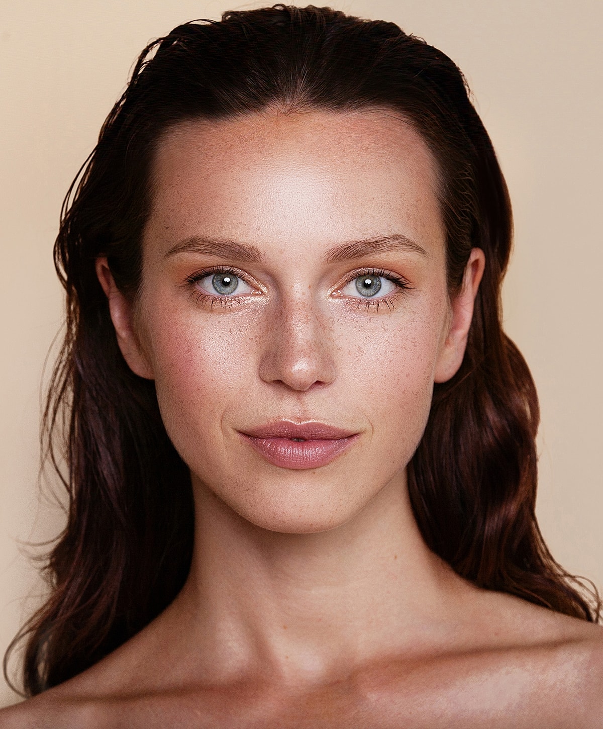 Woman with freckles and blue eyes, natural makeup.