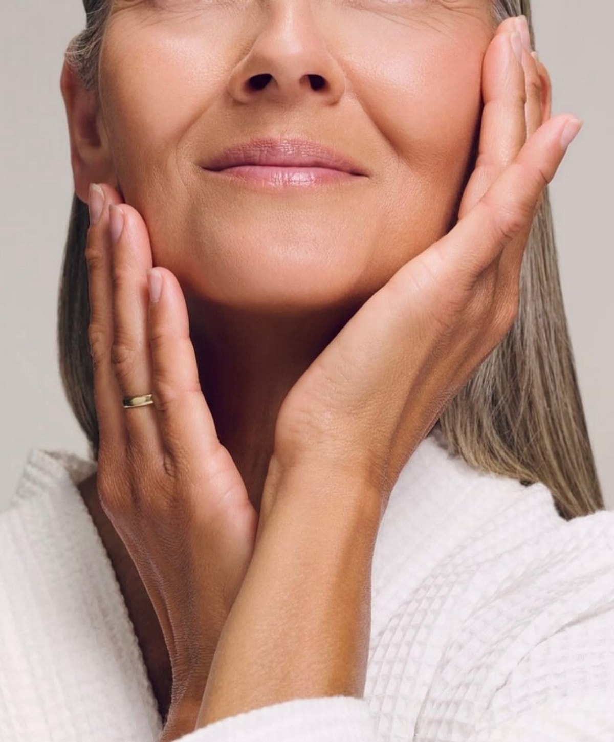 Woman gently touching her face, natural beauty.