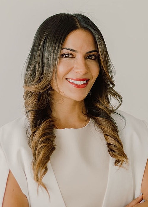 Smiling woman with long hair and red lips.