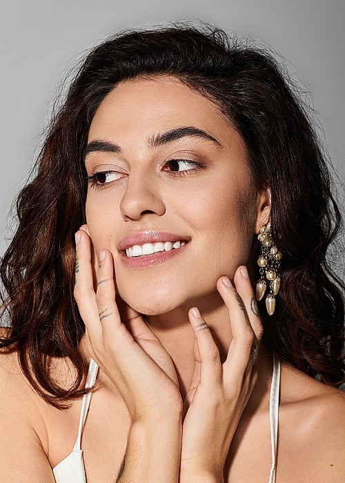 Smiling woman with earrings, natural beauty close-up.