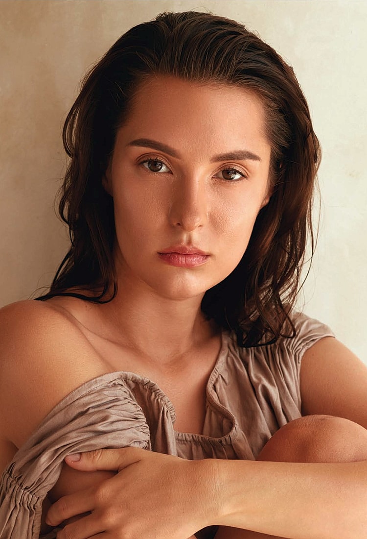 Portrait of woman with natural makeup, relaxed pose.