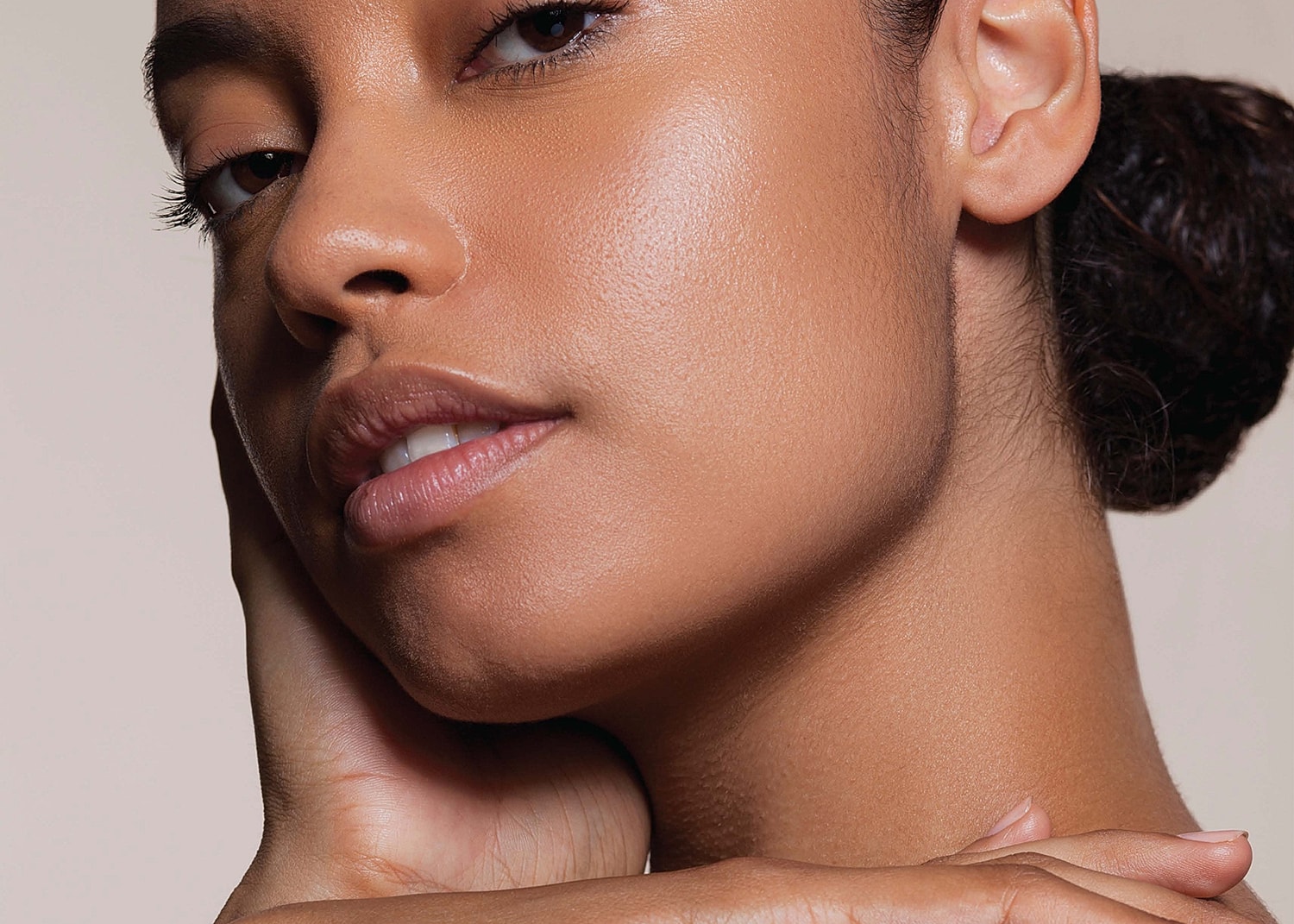 Close-up of a woman's face and hand.