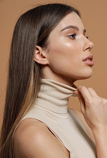 Profile of a woman in beige turtleneck.