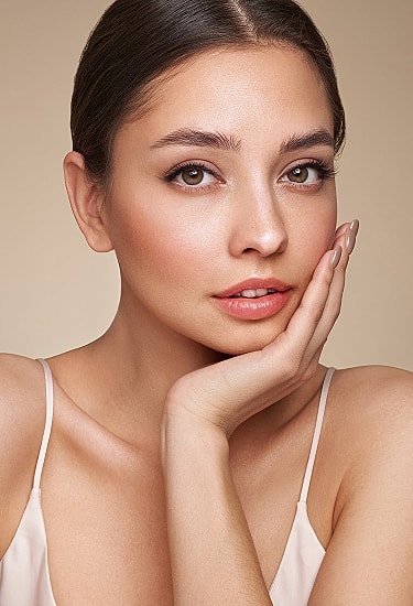 Close-up of woman with natural makeup and expression.