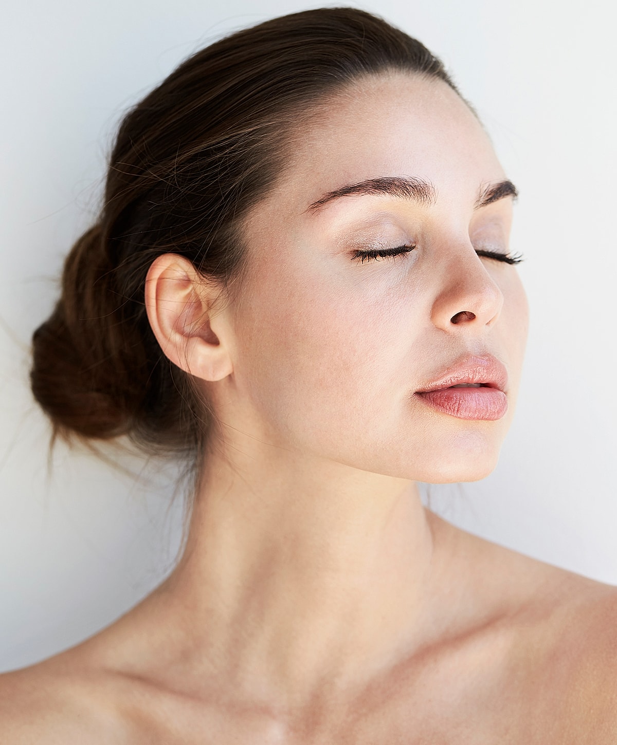 Close-up of serene woman's face with closed eyes.