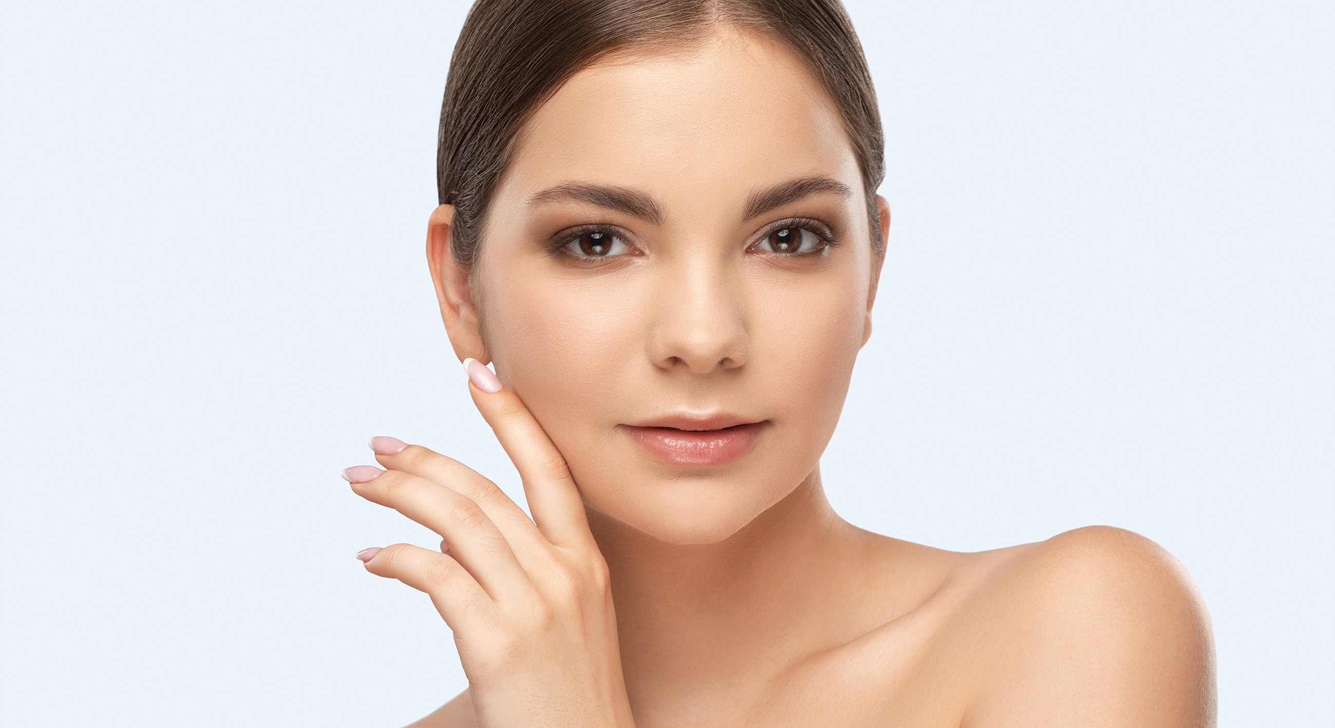 Portrait of a woman touching her face softly.