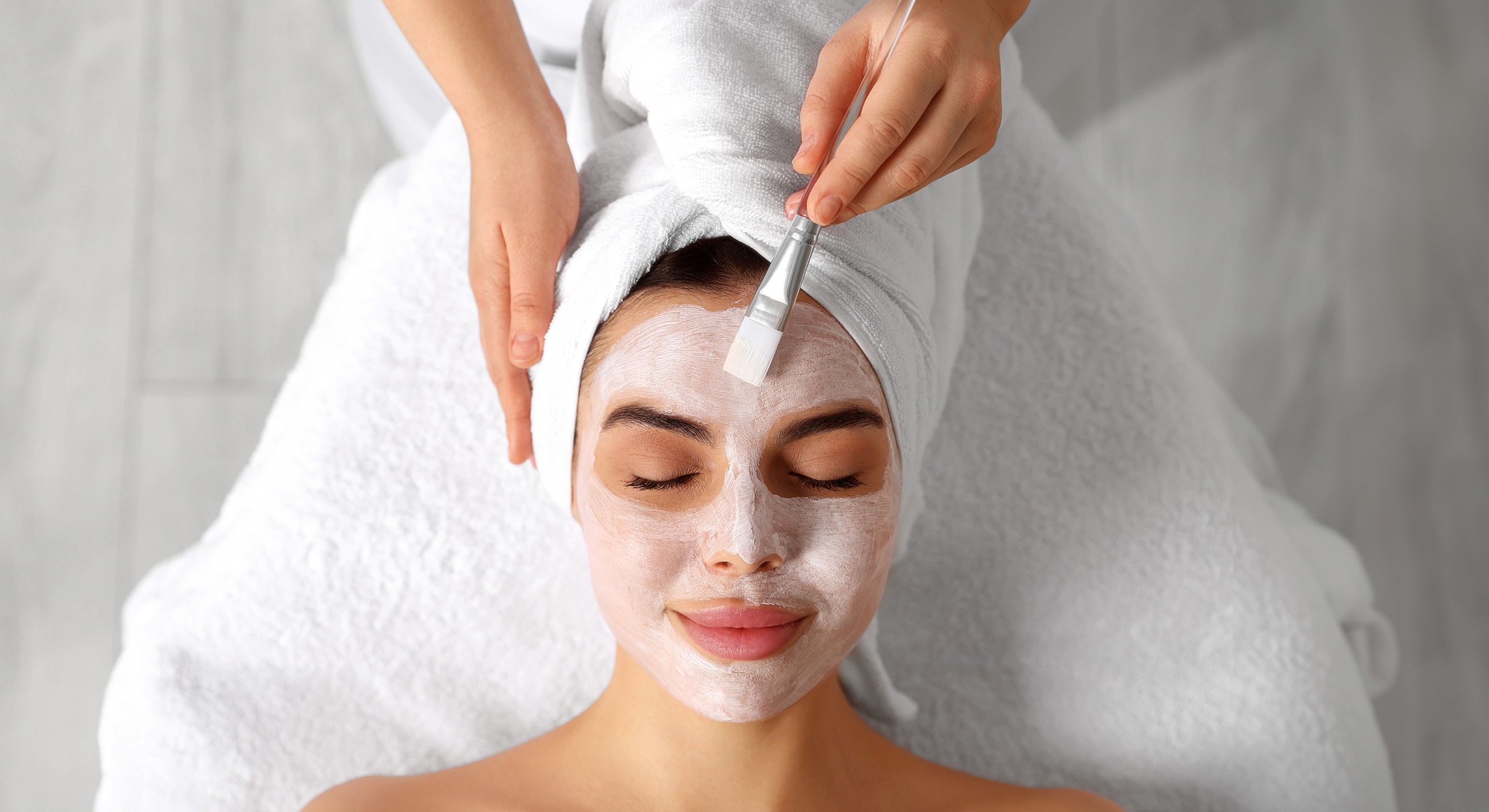 Spa facial treatment with mask application.