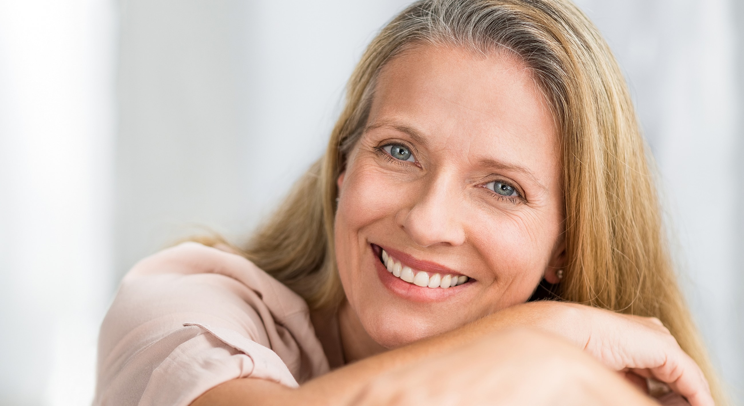 Close-up portrait of a woman with freckles.