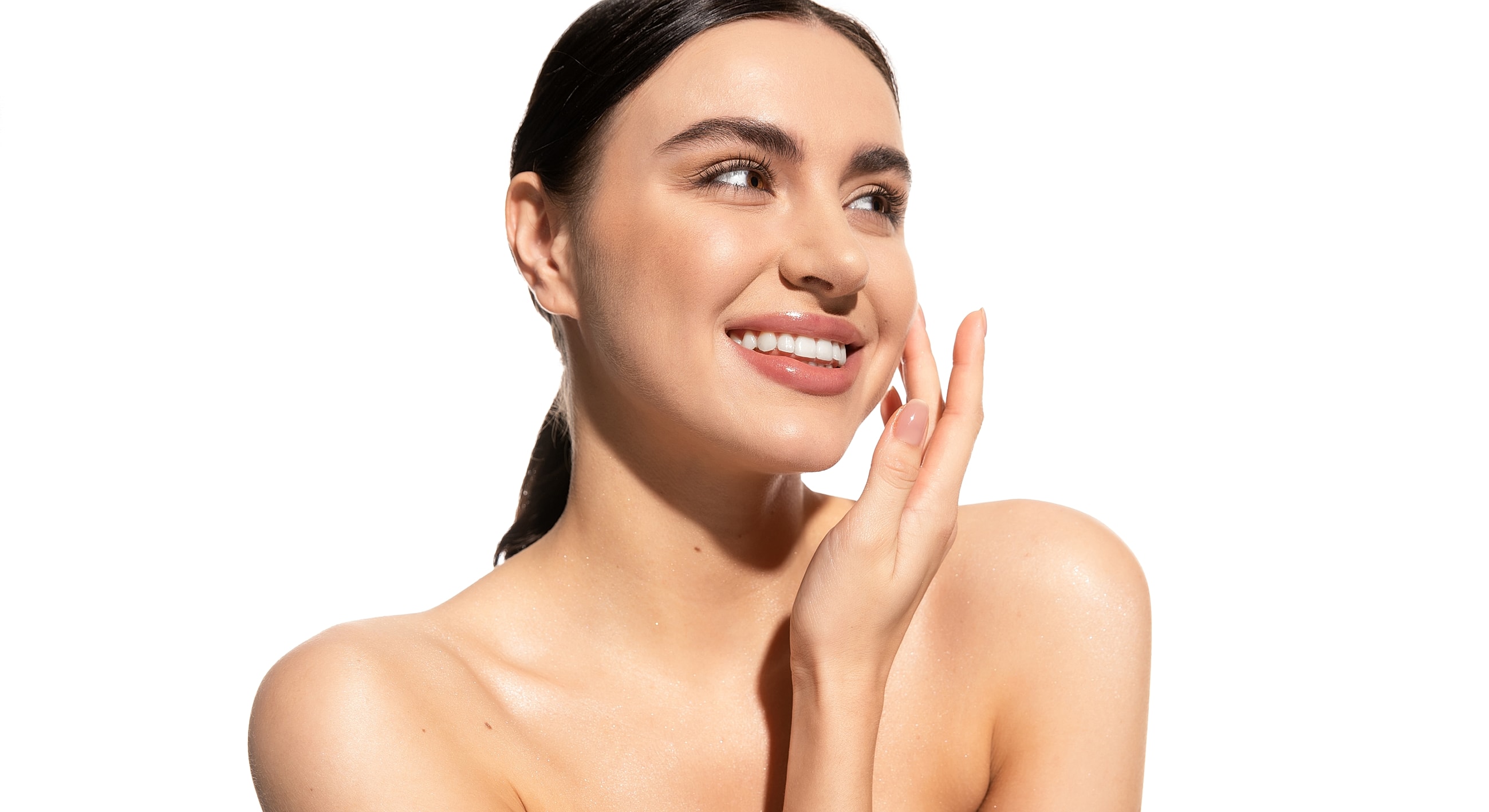 Smiling woman touching her face on white background.
