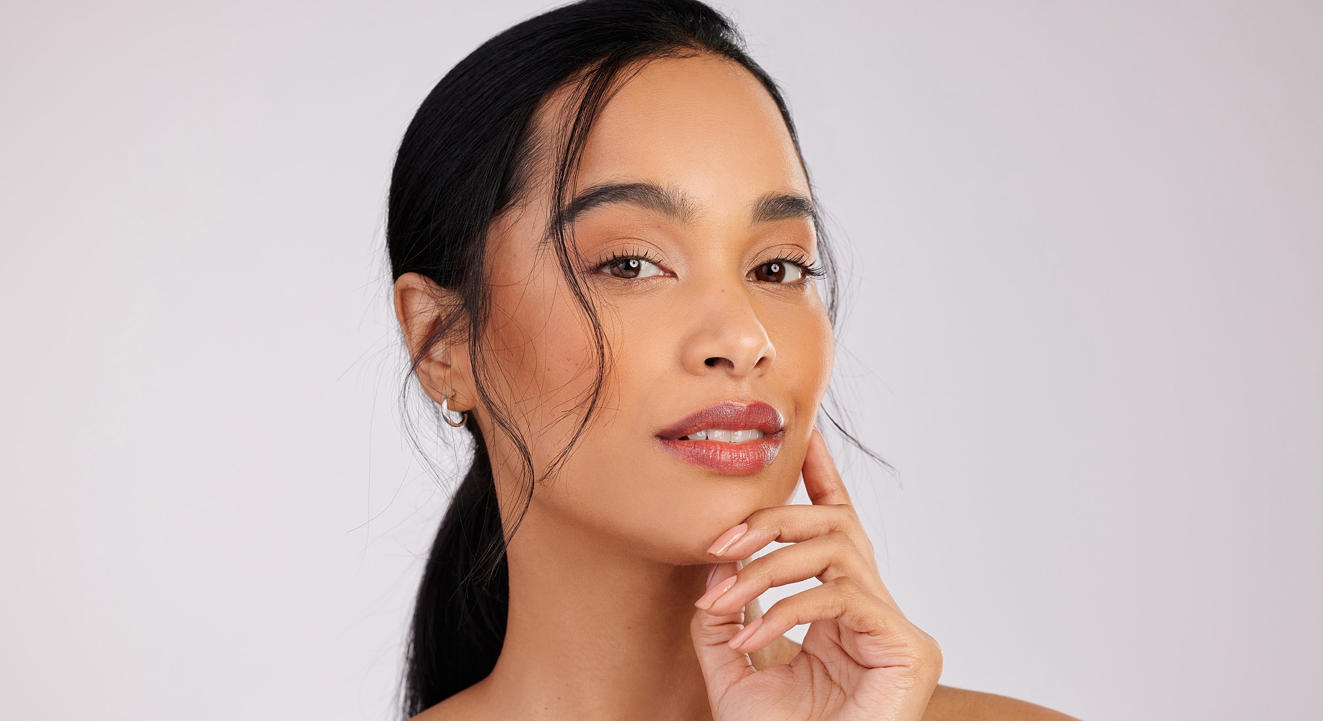 Woman with elegant hairstyle and natural makeup.