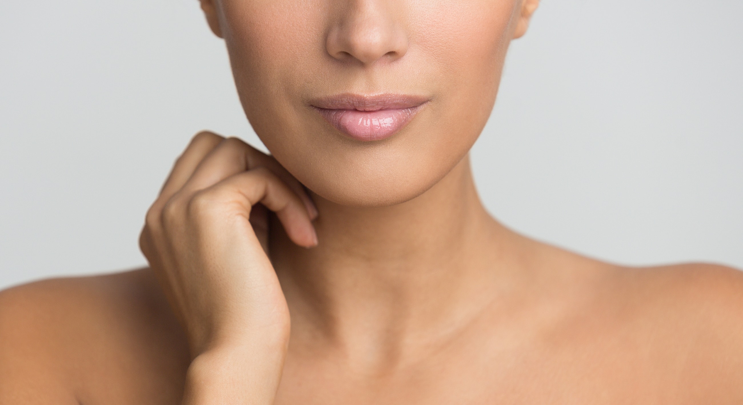 Close-up of a woman's face and hand.