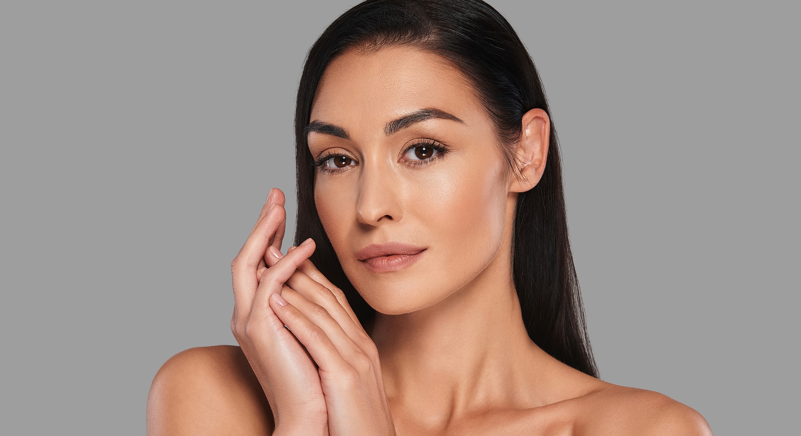 Woman with long hair and natural makeup.